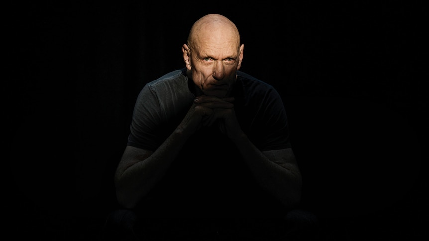 Midnight Oil frontman Peter Garrett poses cloaked in shadow