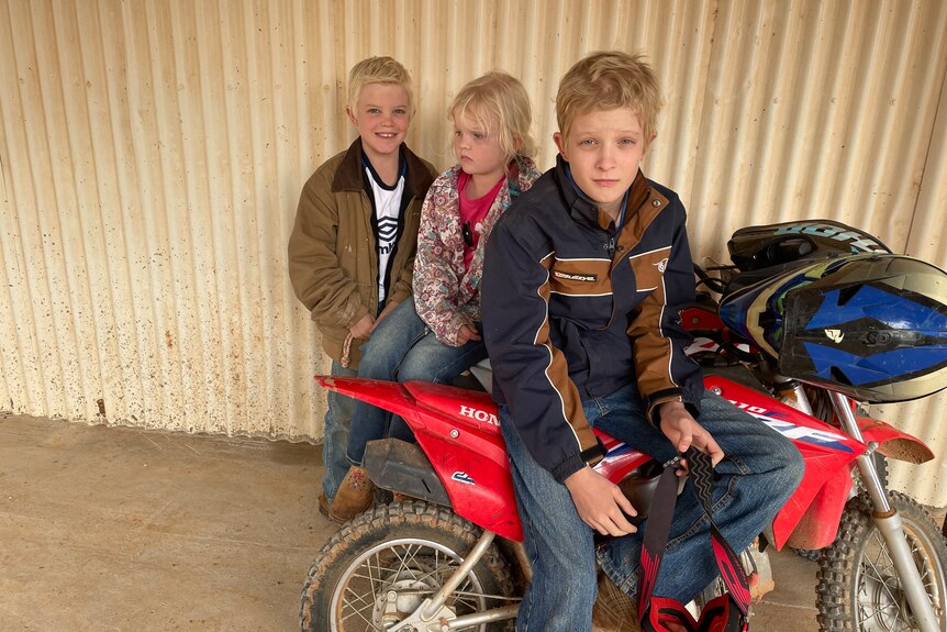 Wyat, Hayley and Sam McGlinchey with a motorbike at Badalia Station