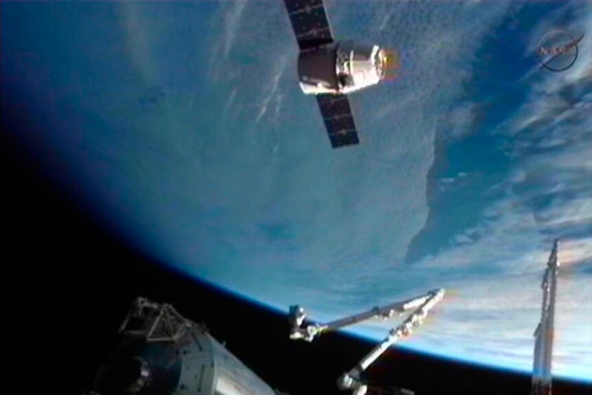 The Dragon cargo craft floating 30 meters from the ISS.