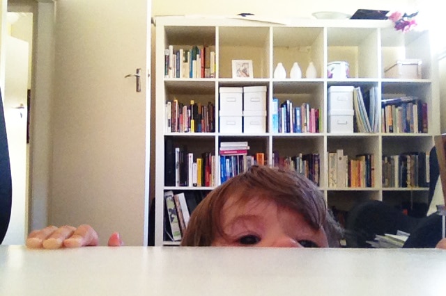 Lisa Schroder's child peeking above her desk.