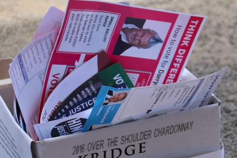 How-to-vote cards in a recycling bin at an early voting centre.