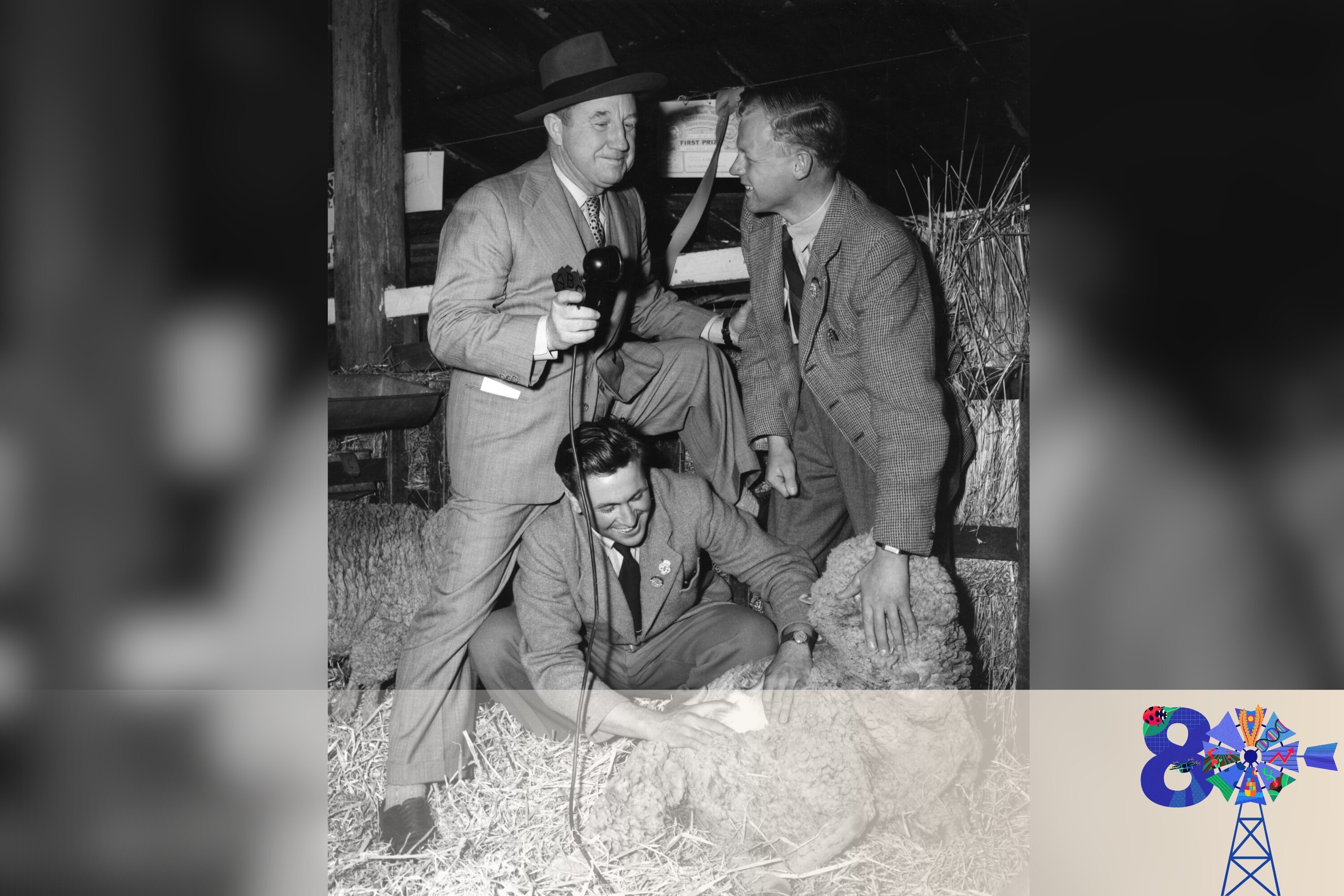 thre men in suits with microphone and a sheep