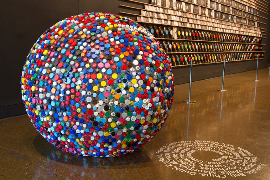 Large ball of colourful plastic lids lined all around it.