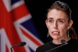 NZ PM Jacinda Ardern addresses a press conference from a lectern in Wellington, New Zealand.