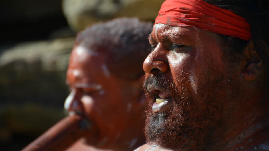 Aboriginal men sing and play didgeridoo