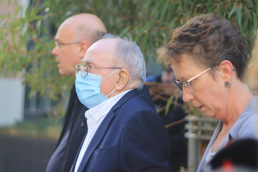 Hugh Campbell wearing a COVID mask as he leaves court.