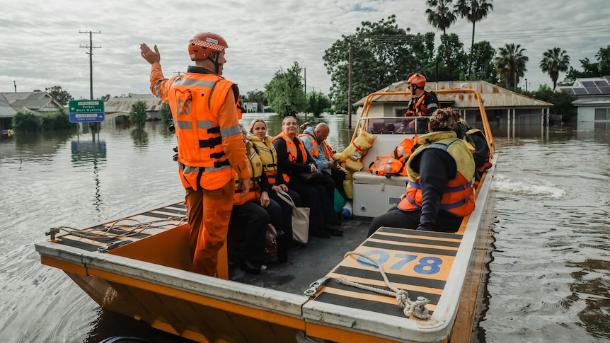 an ses boat with nurses being driven down the street in forbes flood water