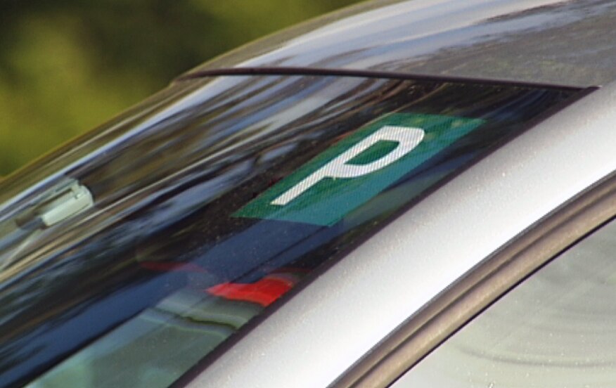 A close up of a P plate on a car windscreen
