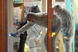 Forensic police collect evidence outside the police station of Joue les-Tours on December 20, 2014 where French police shot dead a man who attacked them with a knife.