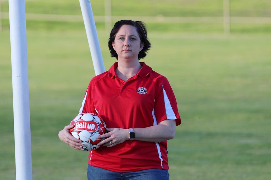 Renae Fussell holding a soccer ball.