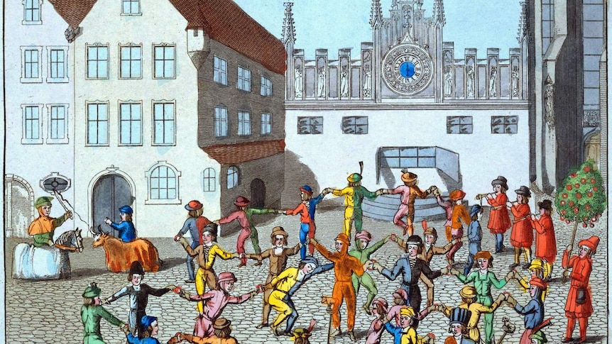 medieval image of people dancing in a square under a town clock.