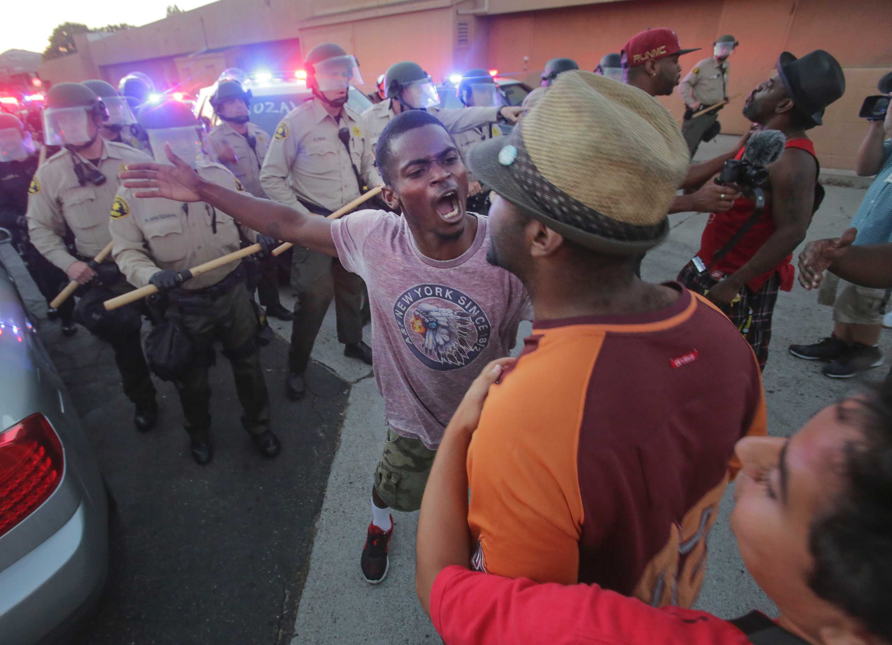 Protests grow tense after fatal police shooting of black man in ...