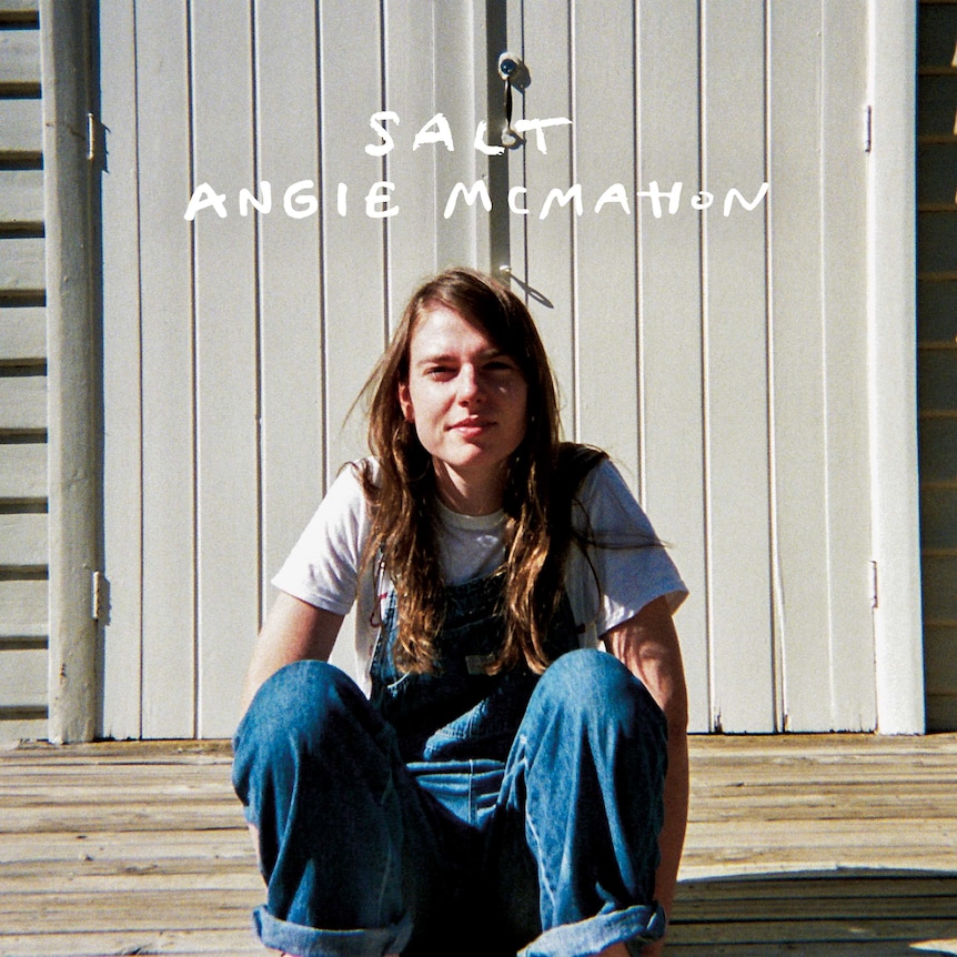Front cover of Angie McMahon's debut album Salt, featuring a photo of her sitting on some stairs.