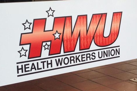 A red and white sign that reads "Health Workers Union"