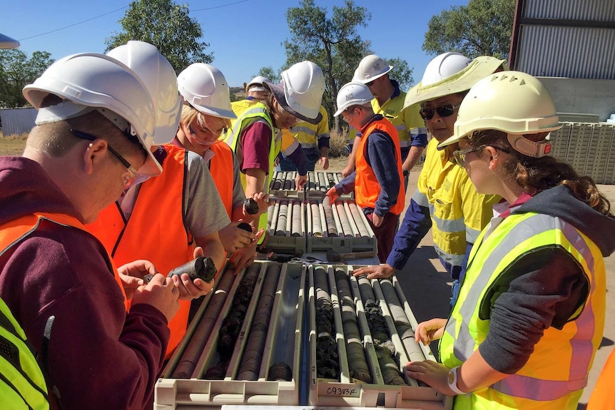 Students looking at core rock samples