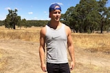 Sam Barnett standing on a rural property in sunshine