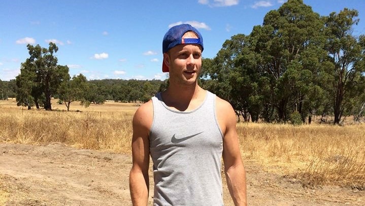 Sam Barnett standing on a rural property in sunshine