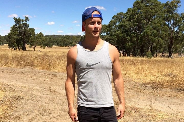 Sam Barnett standing on a rural property in sunshine.