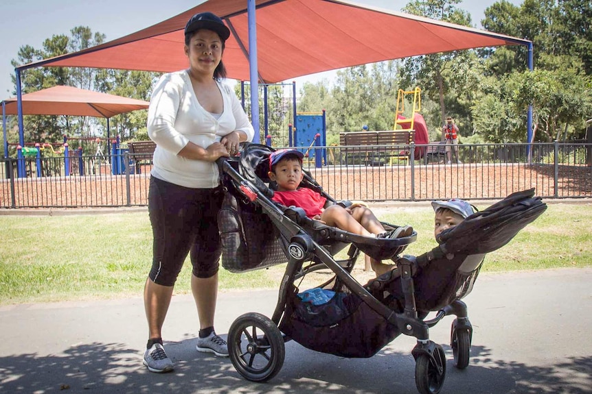 Mum and kids walking through a playground