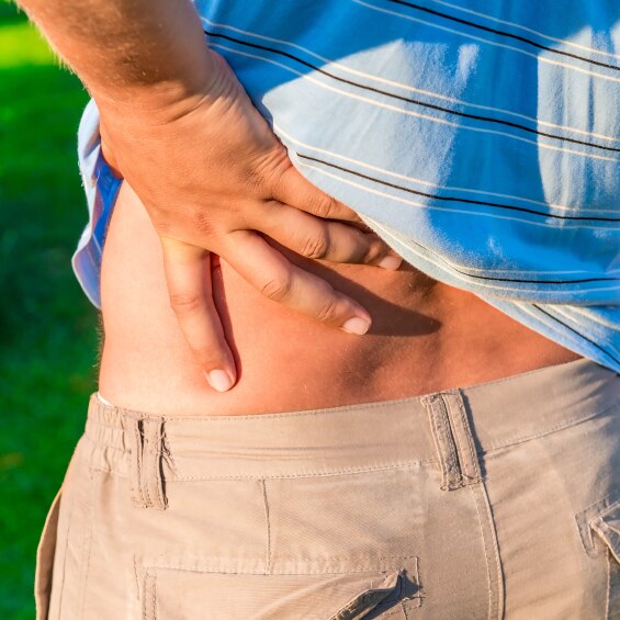 Man holding his hand sore lower back