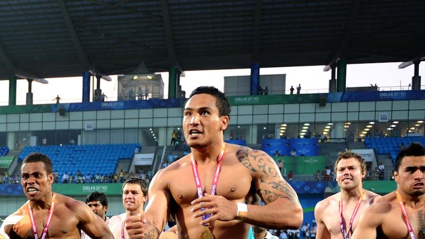 The New Zealand rugby sevens team performs an impromptu haka for its fans after claiming gold