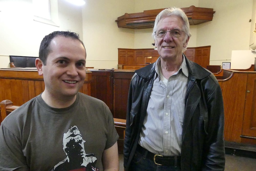 Two men in a courtroom.
