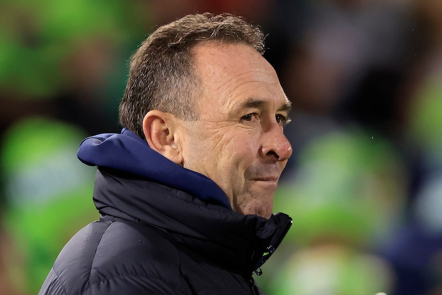 The Canberra Raiders NRL coach looks to his right during a match.