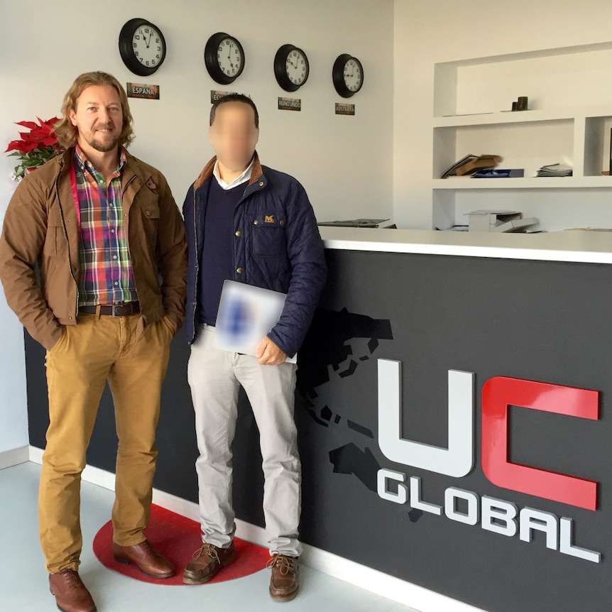 Morales and another unidentified man at the UC Global reception desk.