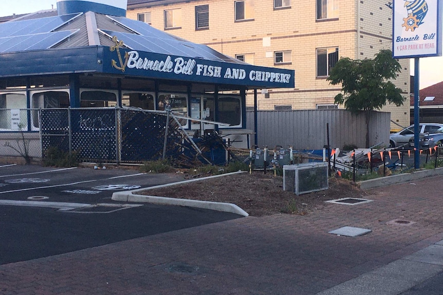 A damaged fence in front of Barnacle Bill's