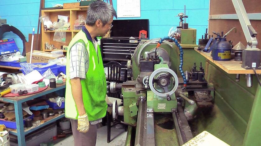 An employee at Associated Gaskets works a lathe at the company workshop