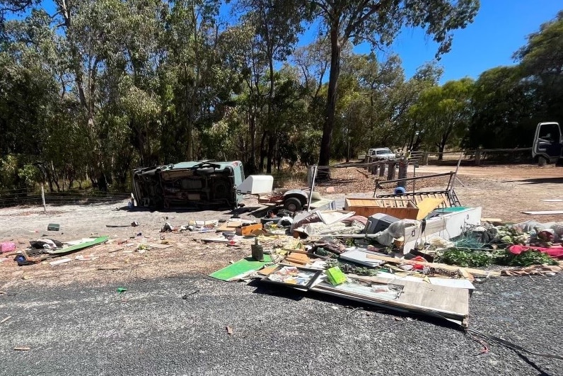 A smashed up car on the side of the road.