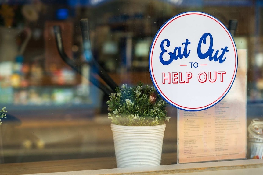 An Eat Out to Help Out sign in a restaurant window