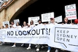 Demonstrators holding signs reading 'Keep Sydney Open' protest against the NSW Government's lockout laws.