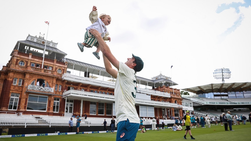 Pat Cummins throws his son into the air