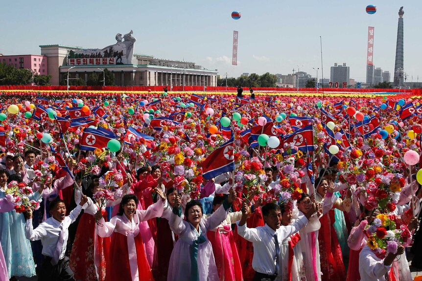 Participants cheer as they take part in a parade for the 70th anniversary of North Korea's founding day in Pyongyang