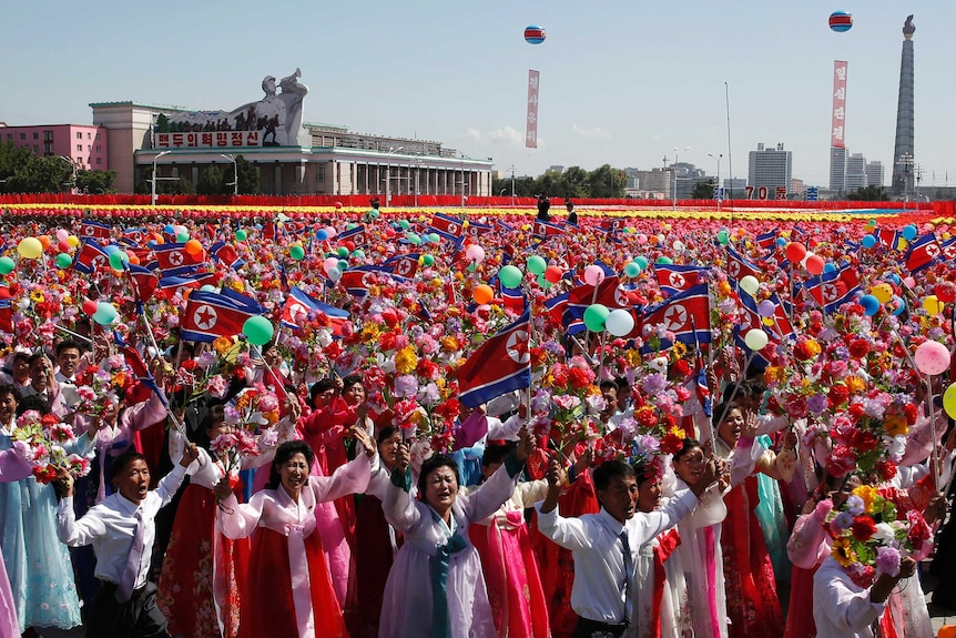 Participants cheer as they take part in a parade for the 70th anniversary of North Korea's founding day in Pyongyang