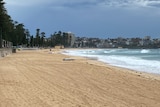 The waves roll into an empty Manly beach after it was shut due to a coronavirus cluster.