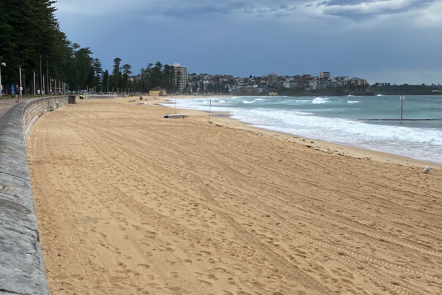 The waves roll into an empty Manly beach after it was shut due to a coronavirus cluster.