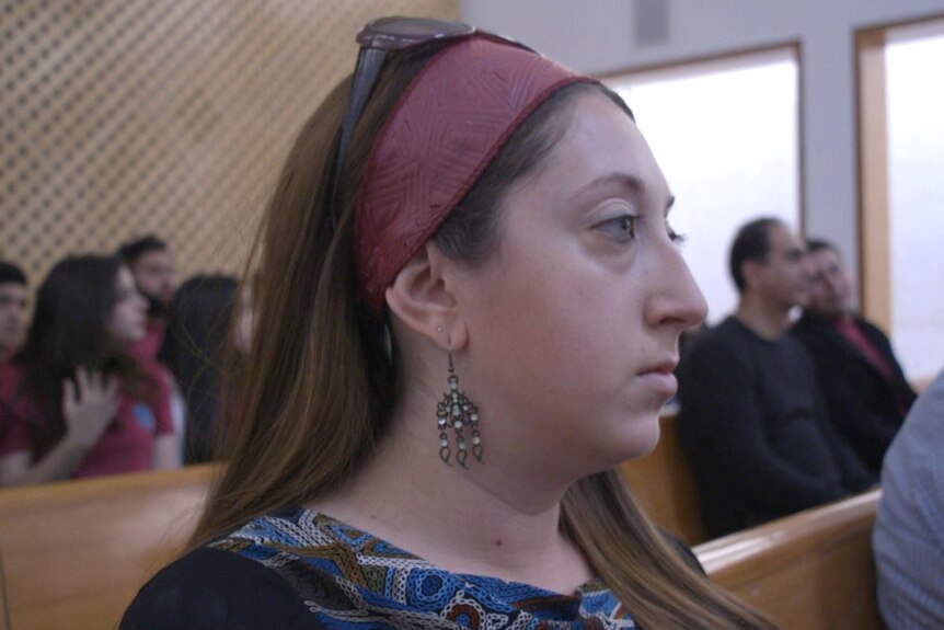Shana Aaronson listens intently in the courtroom.