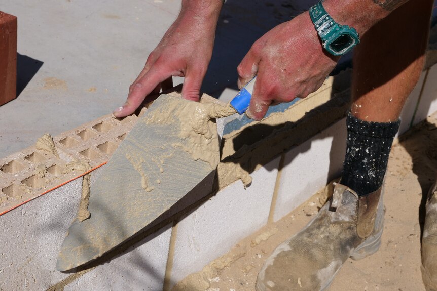 A close up of a bricklayer.