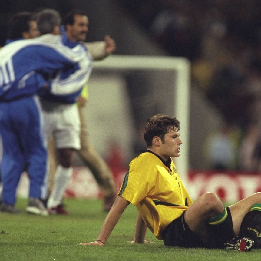 Mark Viduka sits dejected on the MCG after Iran knocked Australia out of 1998 World Cup qualifiers.