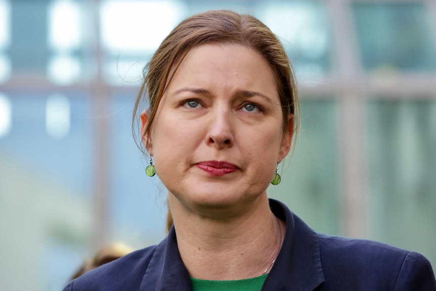 Labor's Julie Collins with pursed lips at a press conference in Parliament House