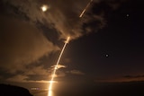 A missile lights up the night sky.