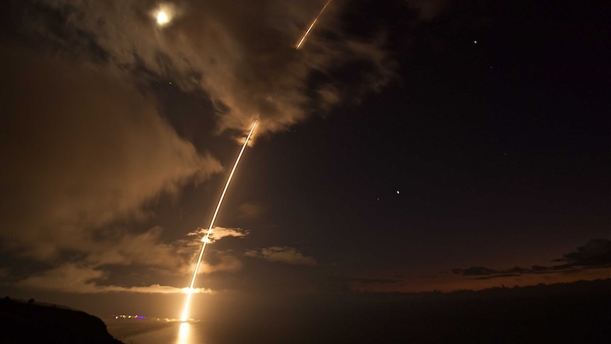 A missile lights up the night sky.