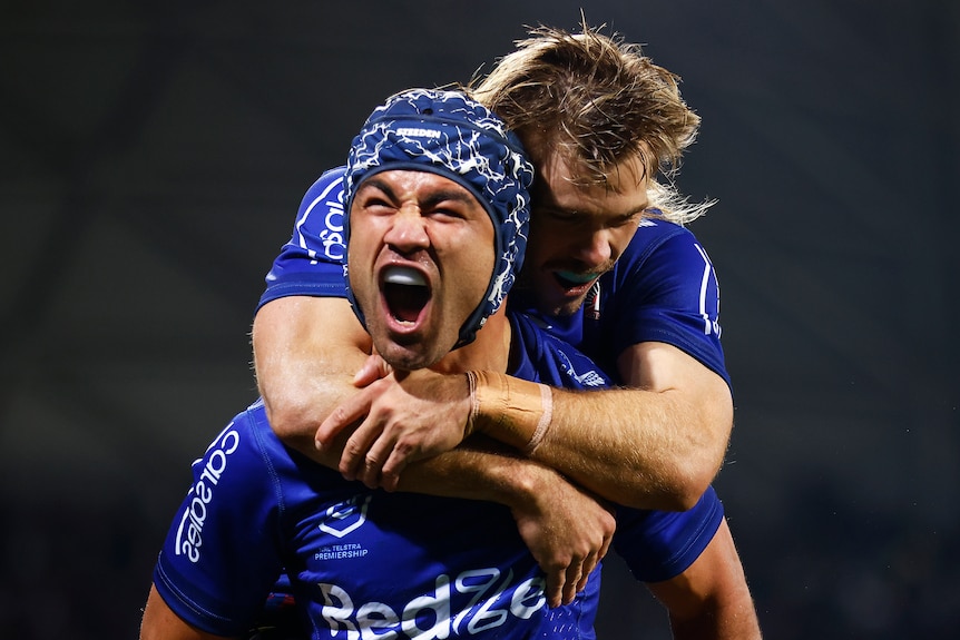 Two rugby league players celebrating a try