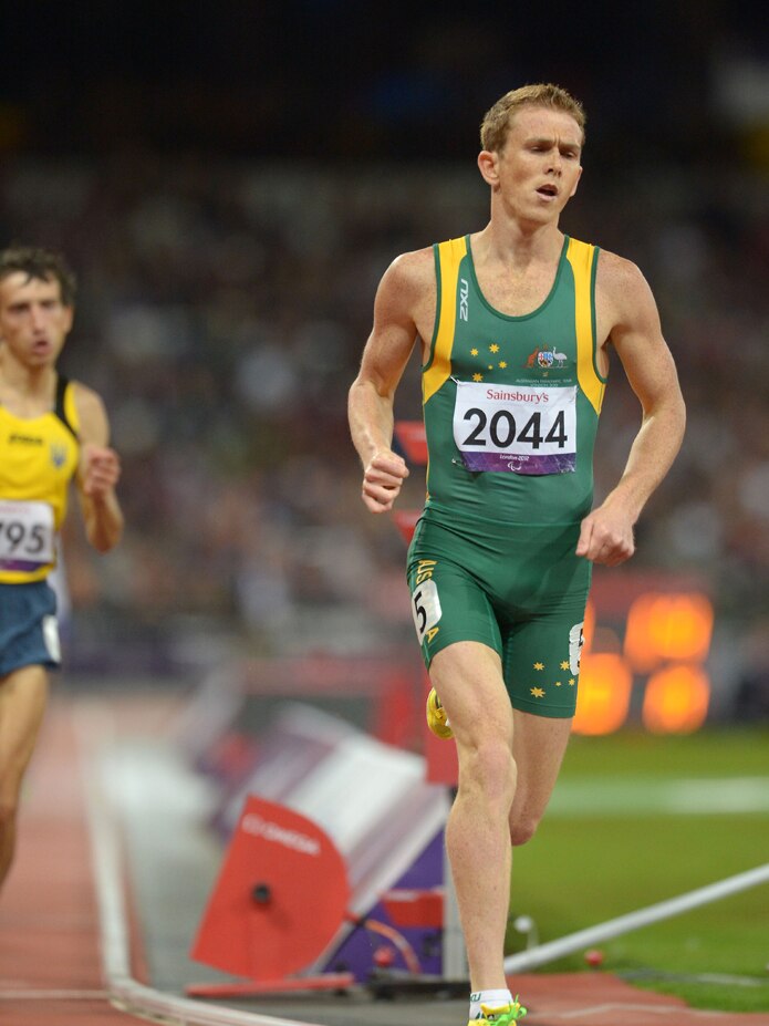 Athlete running on the track in Australian colours