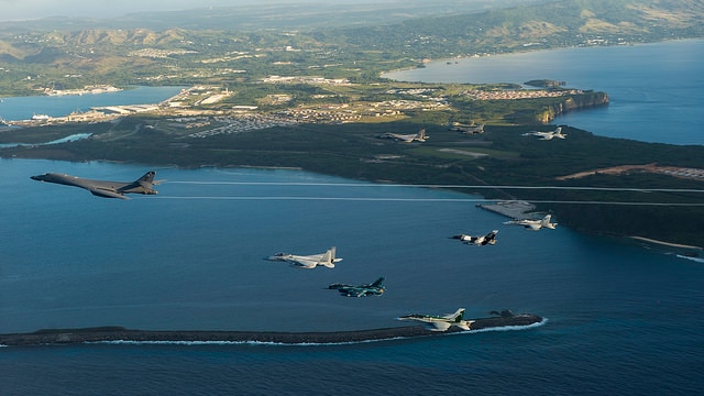 Military airplanes fly in formation over the cost of Guam, Feb. 21, 2017