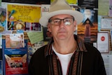 Paul Spooner poses in front of the Byron Community Centre's notice board