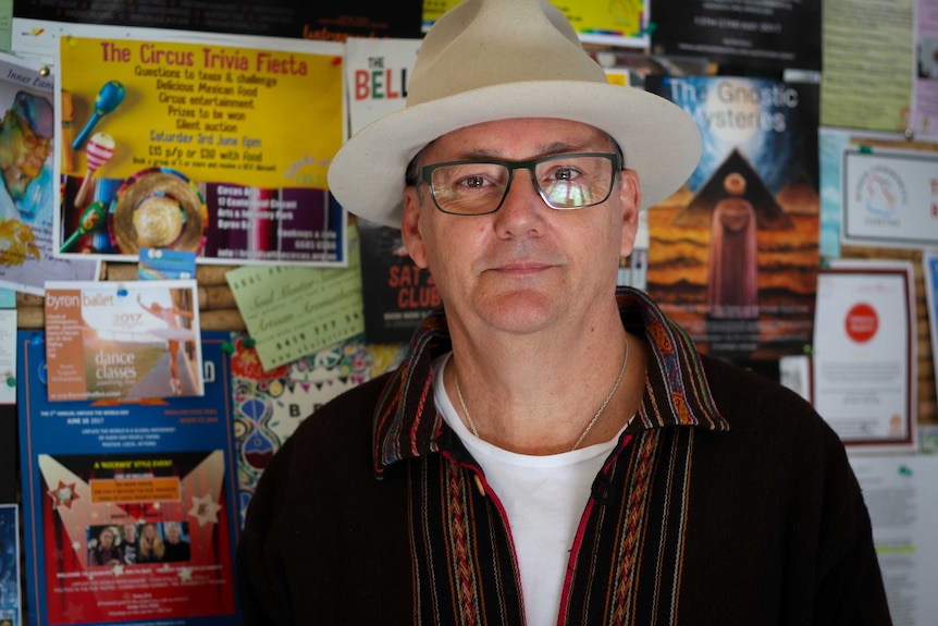 Paul Spooner poses in front of the Byron Community Centre's notice board