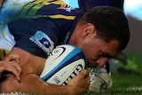 Return pays off ... George Smith bulldozes through the Highlanders' defence.